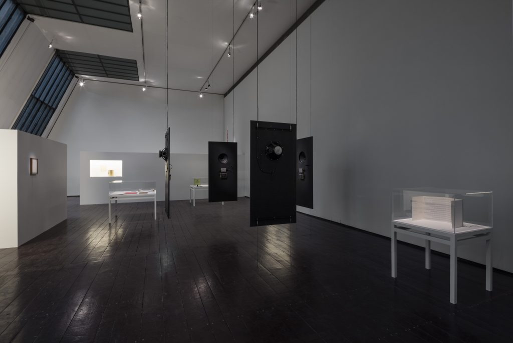 Mario García Torres, Sounds Like Isolation to Me, Acetate, cardboard, ink, linen, magnetic tape, oil, paper, sheet metal, sound, video, wire, wood, Dimensions variable.