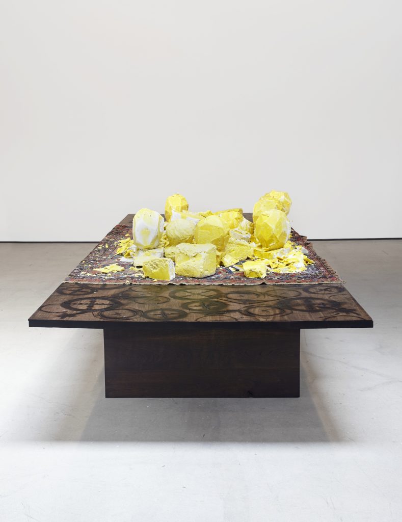 Rashid Johnson 'Untitled (shea butter table)', 2016 Shea butter, Persian rug, branded walnut. 139.7 x 517.5 x 184.2 cm / 55 x 203 3/4 x 72 1/2 in Photo: Martin Parsekain. © the artist, Courtesy Hauser & Wirth  