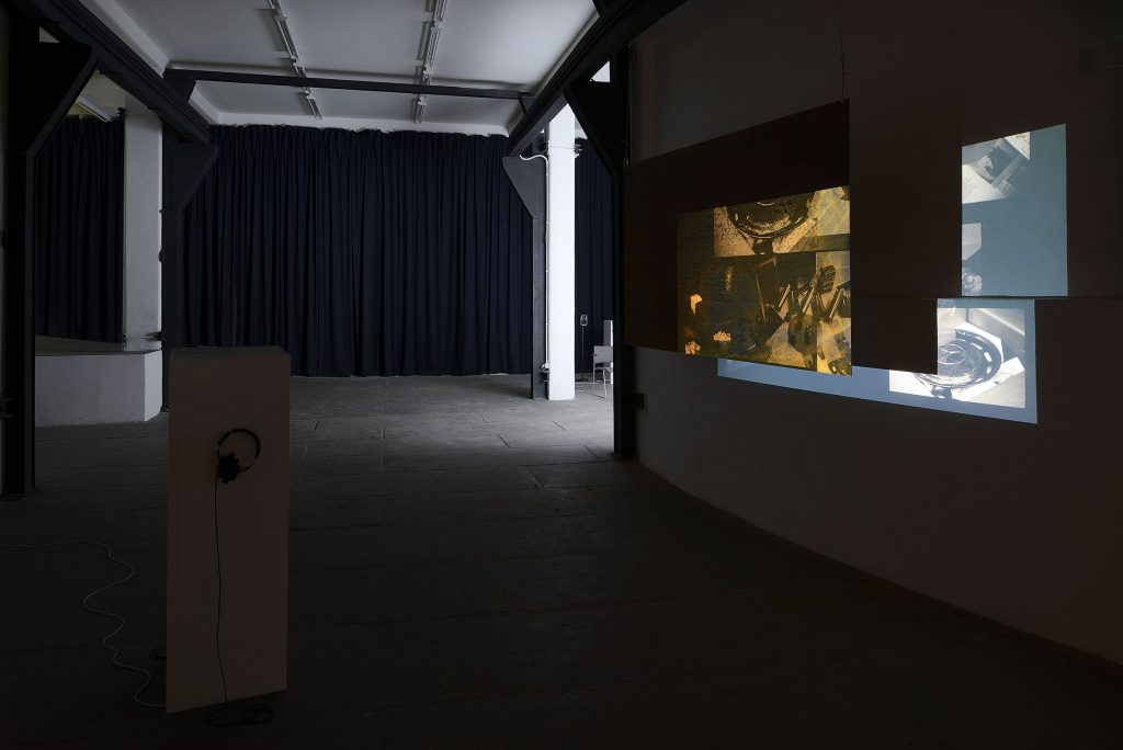 Tris Vonna-Michell 'Postscript III-V (Berlin)', 2016 HD video projection, suspended metal screen, soundtrack on headphones audio: 9 min. 8 sec. metal screen: 150 x 247 cm. Courtesy of the Artist and T293. Photo credit: Roberto Apa.